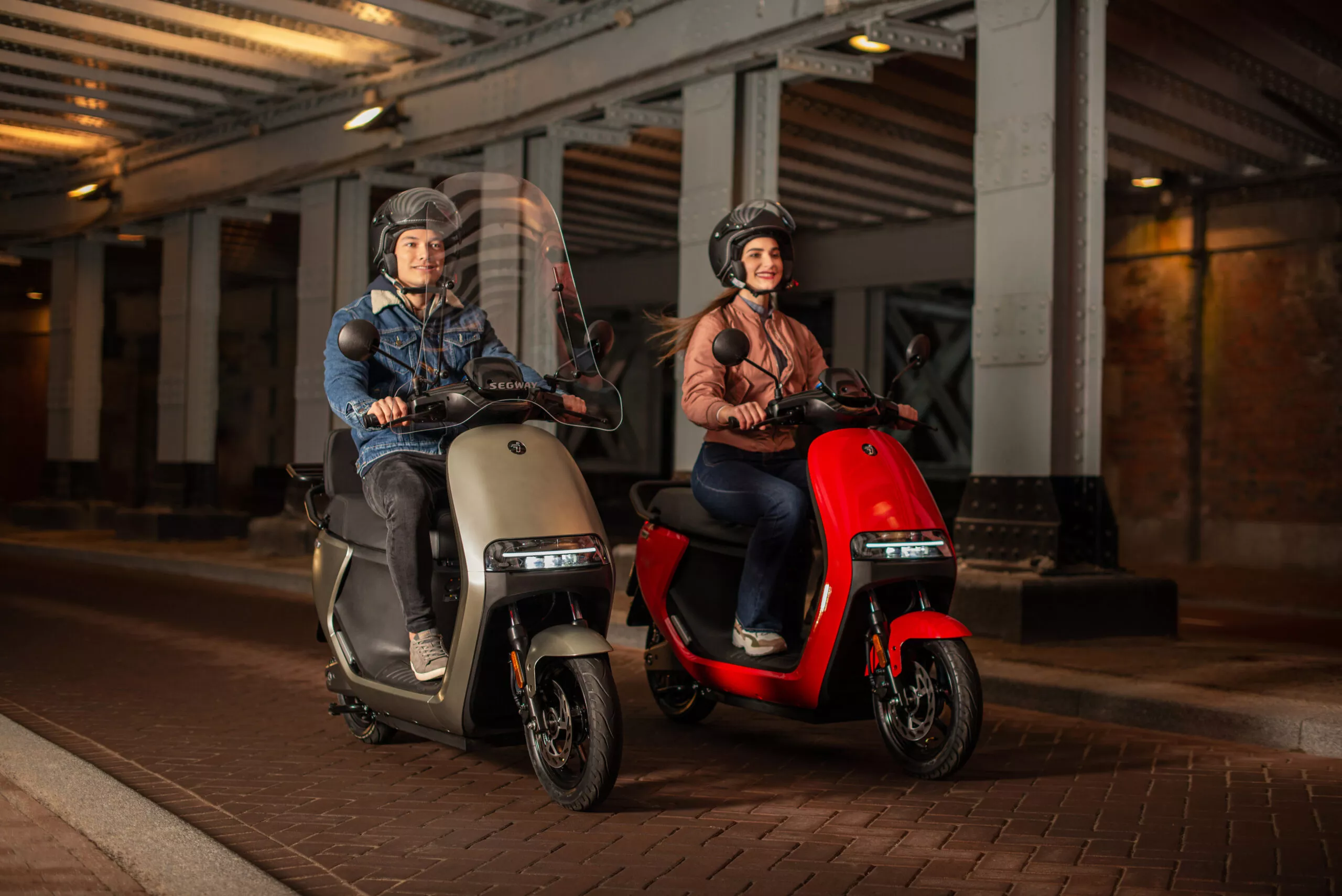 Segway-eScooter_E110S-_Lifestyle_Woman-and-man-riding_front-side-view-scaled.jpg